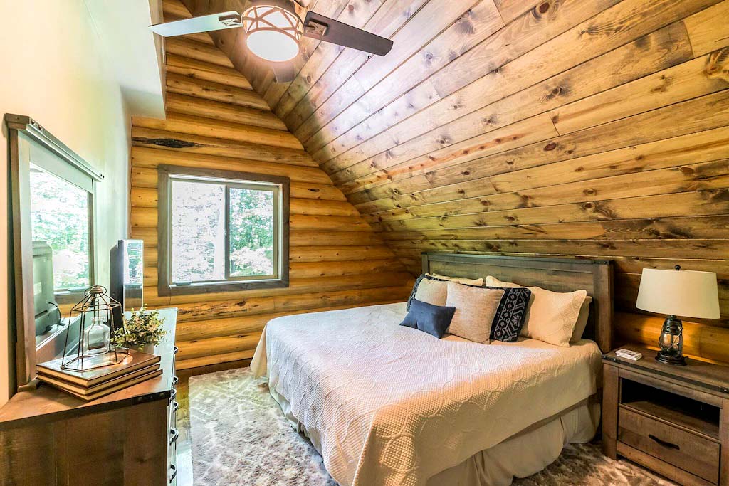 Cozy wooden cabin bedroom with comfortable double bed