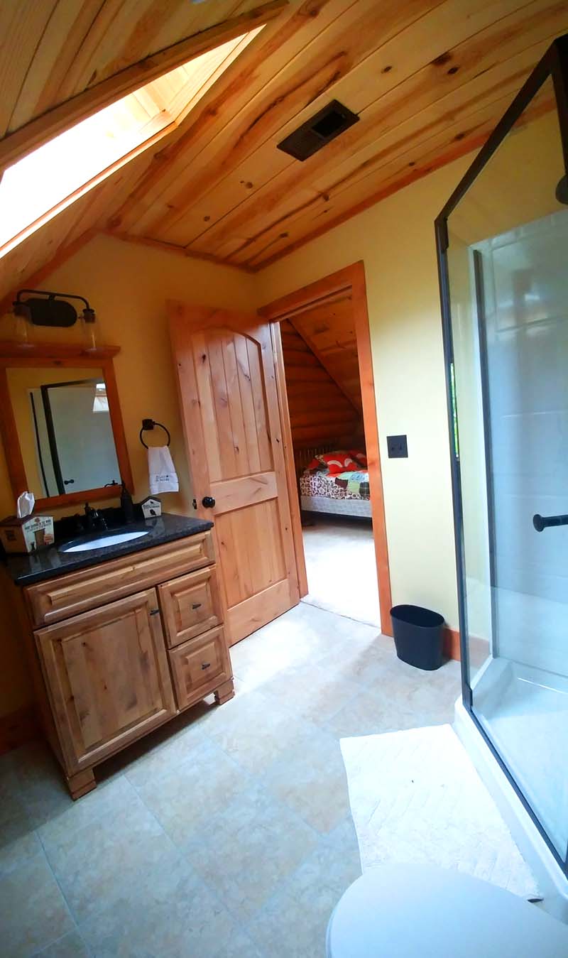 Cascade Lodge Log home design by Lazarus loft bath split with bedroom
