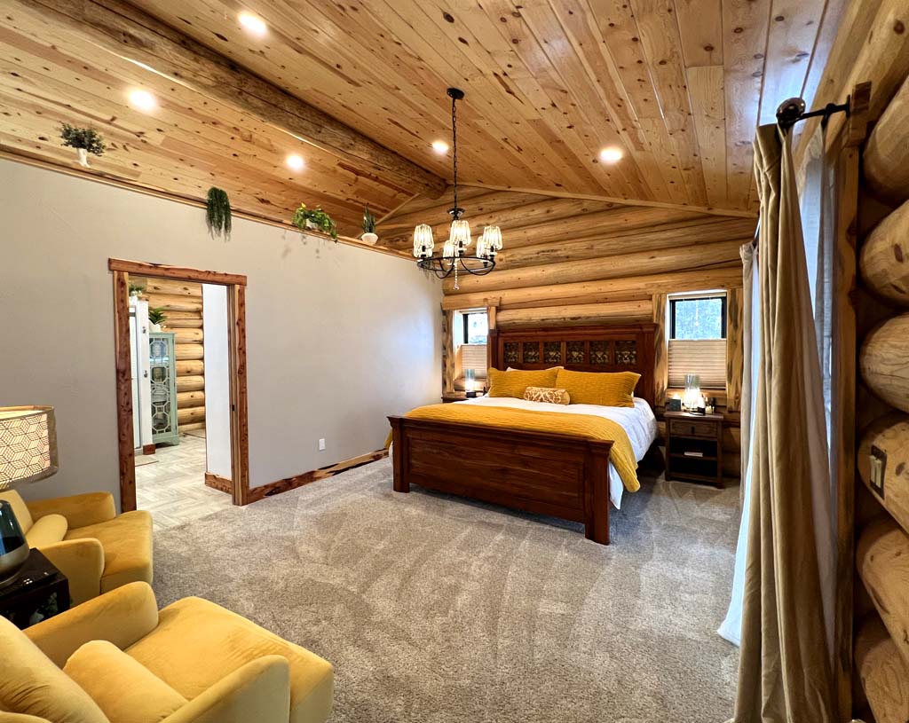 Log Cabin master bedroom sheetrock low wall juniper trim