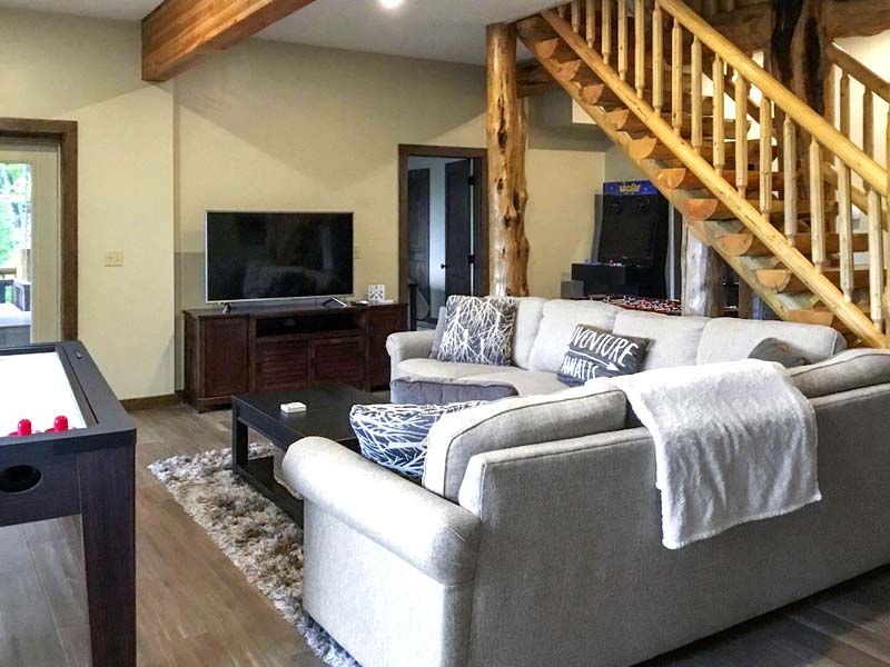 Cozy living room with sofa and wooden staircase interior design