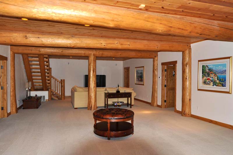basement of a log home cabin plan beams