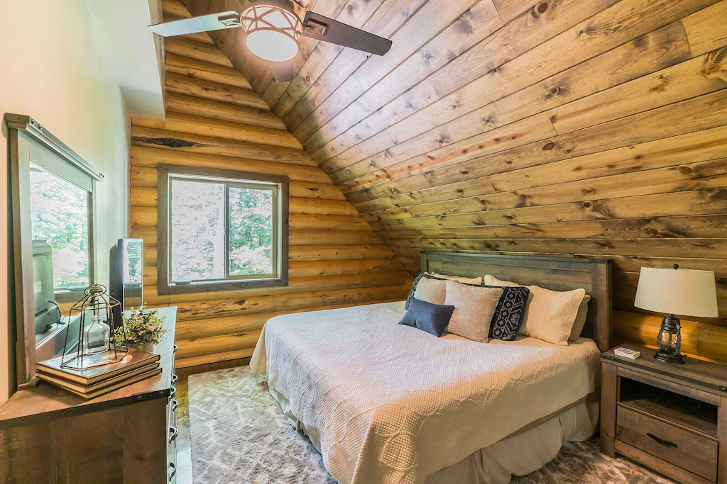 Cozy cabin bedroom with wooden walls and two double beds