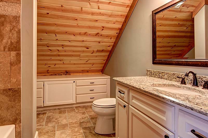 loft bathroom in log home upper with wood ceiling