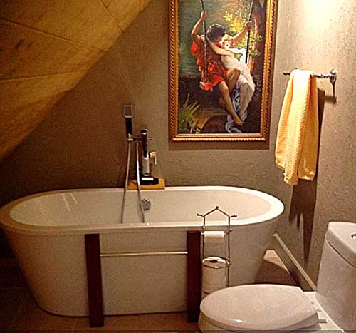 Cozy bathroom with tub and elegant wall art decor