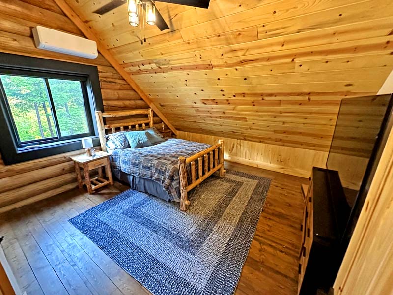 Cozy rustic log cabin bedroom with wooden interior design