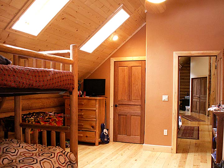 Cozy rustic bedroom with bunk bed and wooden furnishings