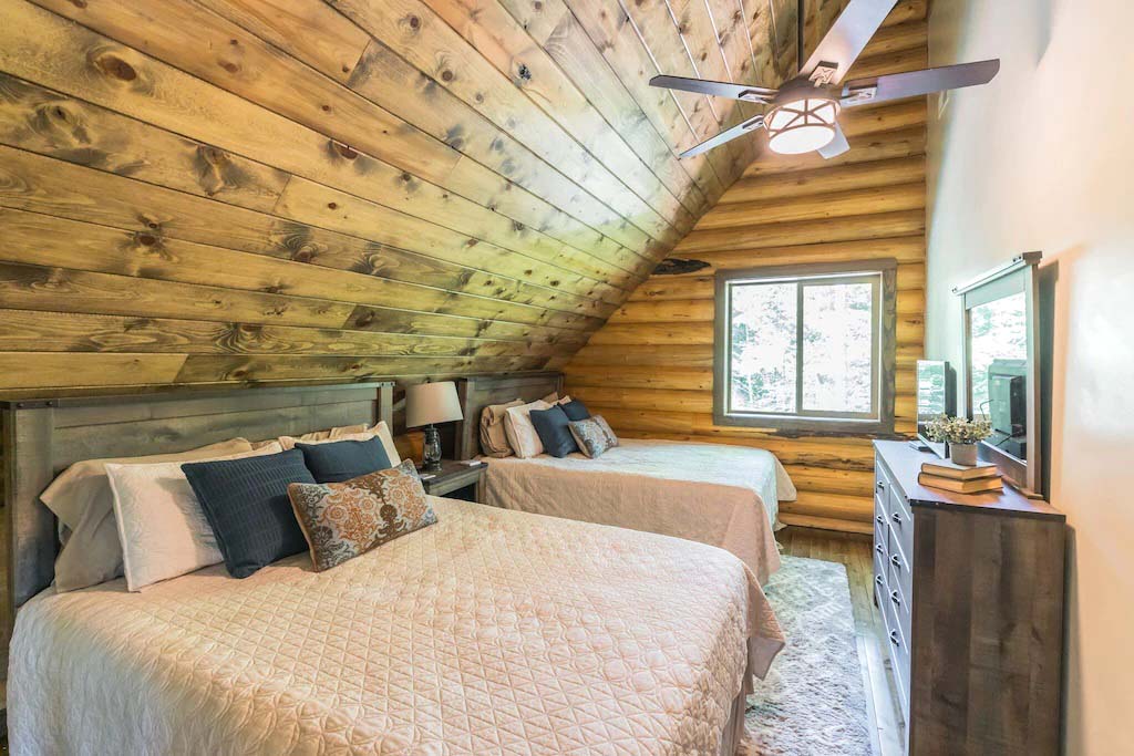 Cozy cabin bedroom with wooden walls and twin beds