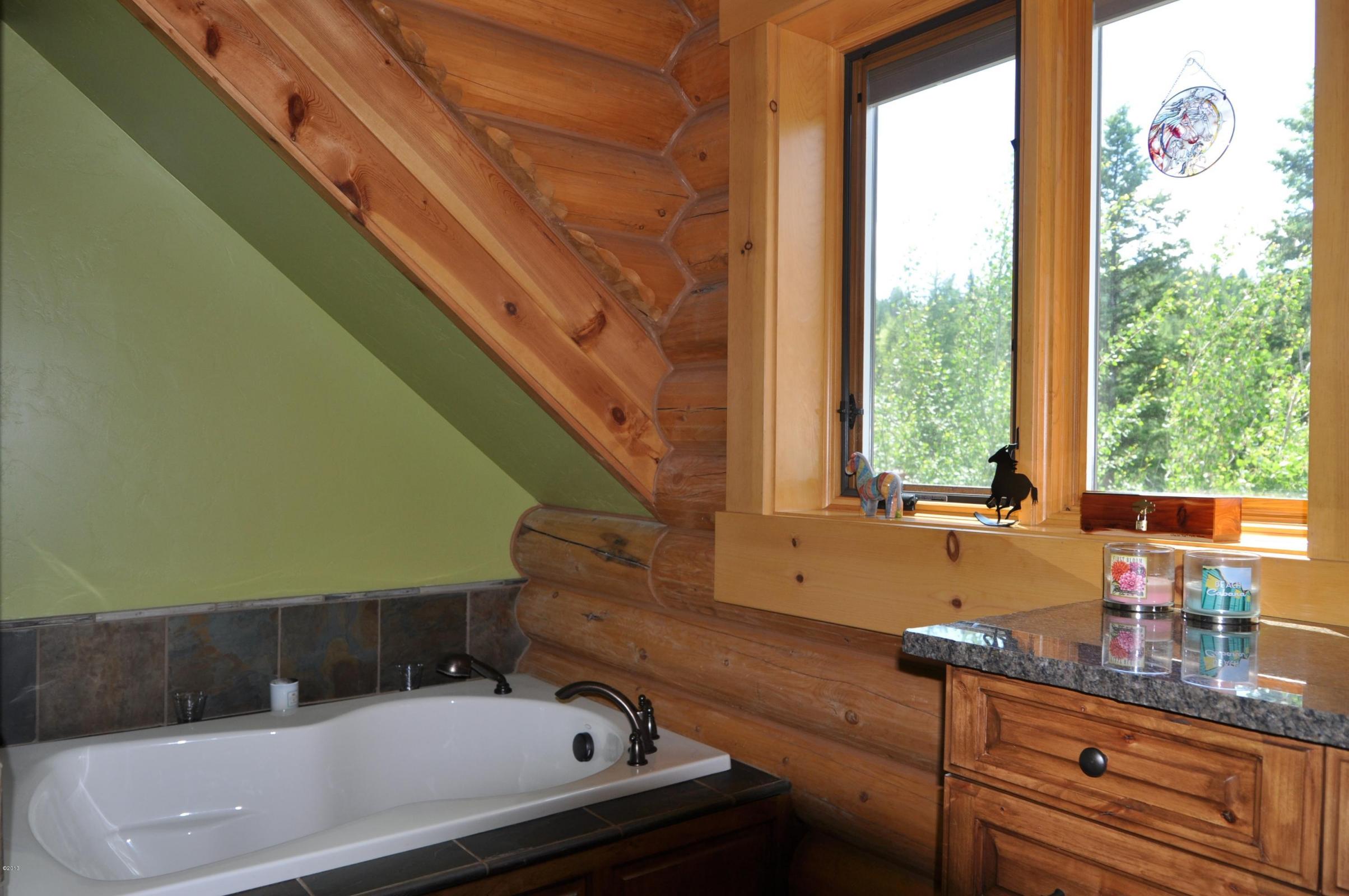 Cozy rustic bathroom with wooden accents and a scenic view