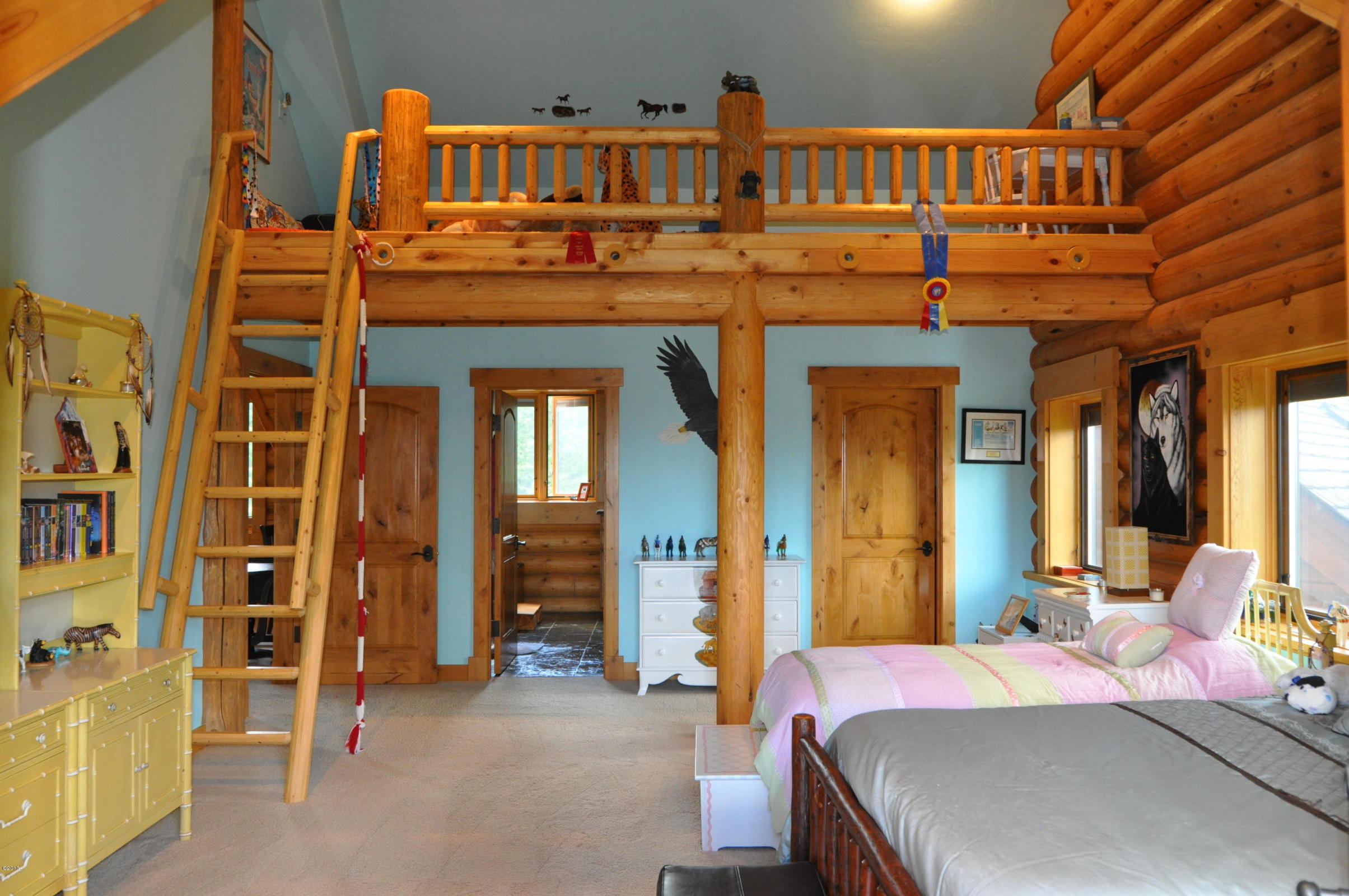 Cozy log cabin bedroom with rustic wooden loft and decor