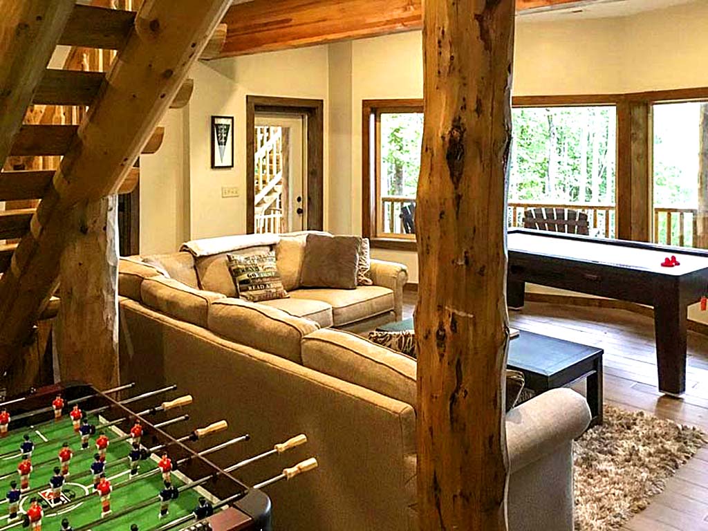 Cozy living room with games and plush seating in cabin setting