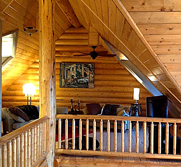 Cozy log cabin loft with wooden interior and comfy seating