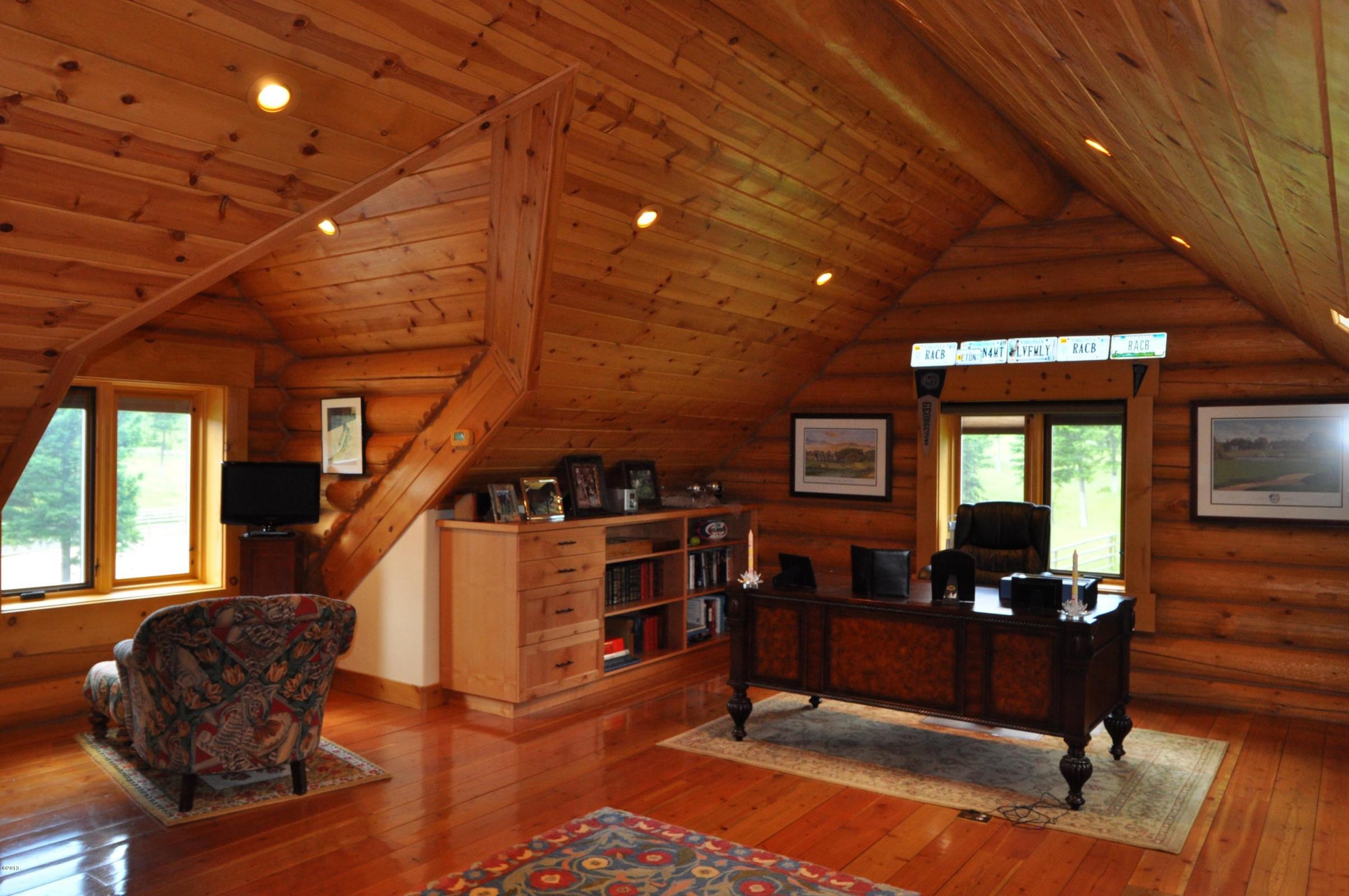 Rustic home office with wood paneling and natural light