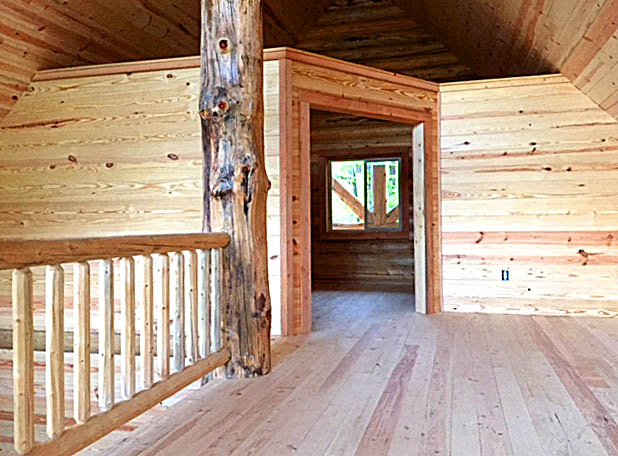 Spacious rustic wooden interior with natural light and beams