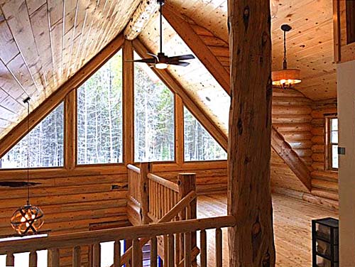 Spacious rustic wooden cabin interior with large windows
