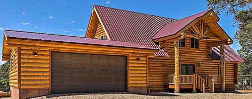 Rustic log cabin with red roof surrounded by evergreen trees