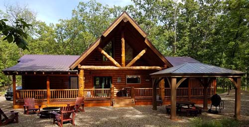 Modern two-story log cabin in forested area construction