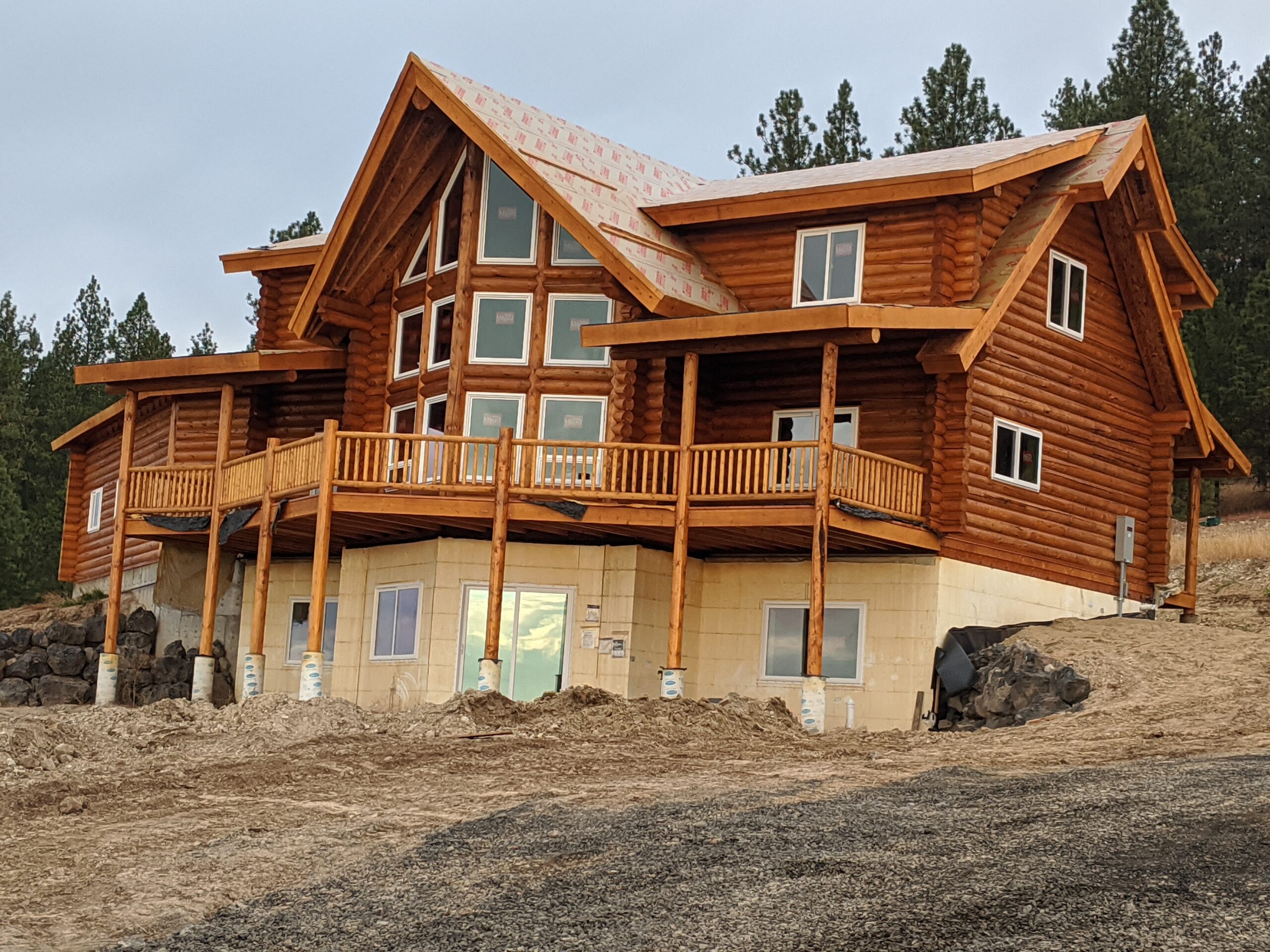 Large wooden cabin in forested mountain area landscape