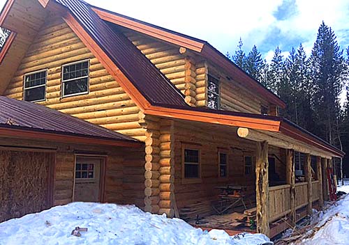 Log cabin with snowy surroundings in a forest setting