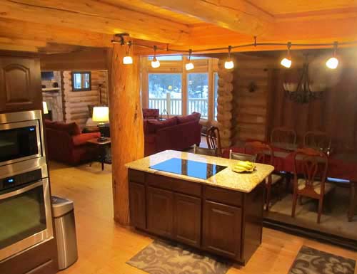 Cozy rustic cabin kitchen and dining area with warm lighting