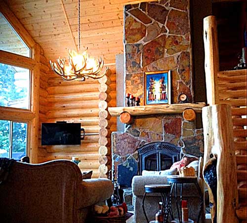 Cozy log cabin interior with stone fireplace and warm lighting