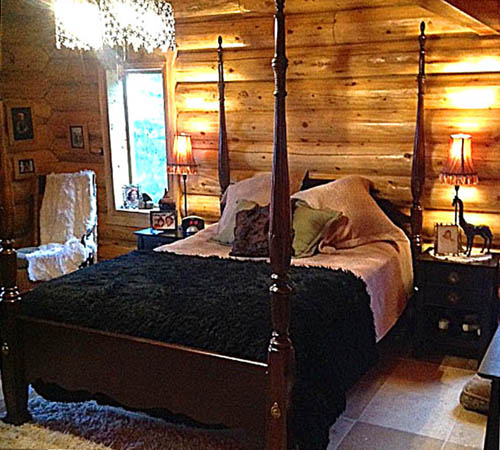 Cozy log cabin bedroom with rustic furniture and warm lighting