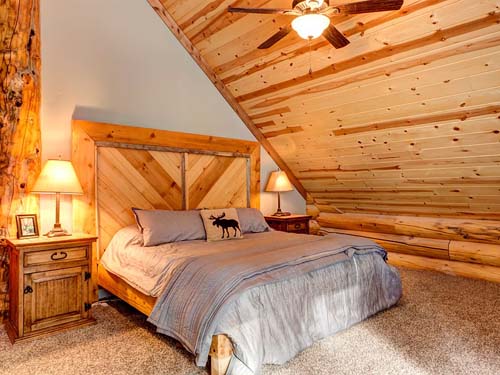 Rustic bedroom with wooden bed frame and cozy decor