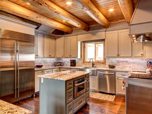 Spacious rustic kitchen with wooden beams and modern appliances