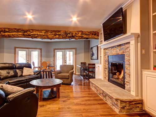 Cozy living room with fireplace and elegant furniture setup.